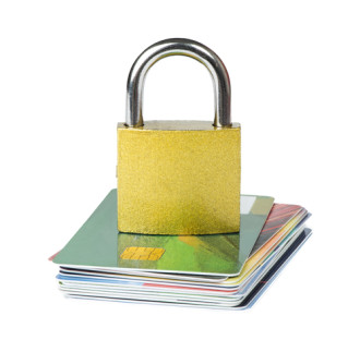 Image of a padlock sitting on a stack of credit cards
