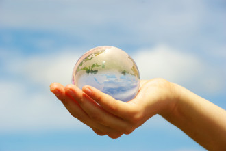 Image of a globe cupped in an extended hand